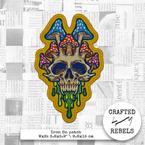 May include: An iron-on patch featuring a colourful skull with mushrooms growing out of its head. The skull is dripping with green, yellow and orange paint. The patch is 9.6 cm by 15 cm.