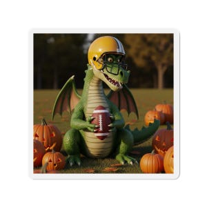 May include: A green dragon wearing a yellow football helmet and holding a brown and white football. The dragon is surrounded by carved orange pumpkins on a grassy field. The background shows trees and a blurred sky.