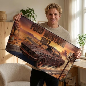 May include: A white ceramic mug with a black handle and the text "But First, Coffee" in a bold, black font. The mug is set against a blurred background, highlighting its simple design.