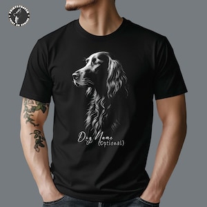 May include: Black t-shirt featuring a detailed, grayscale illustration of a dog's profile. The dog has long, flowing fur. The text "Dog Name (Optional)" is below the image. The shirt has a crew neck and short sleeves.