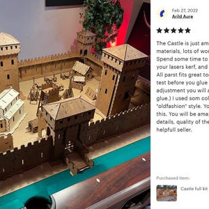 May include: A detailed wooden model of a medieval castle with a moat, drawbridge, and multiple towers. The model is assembled on a green felt surface. The image includes a five-star review and a comment from a customer who purchased the model.