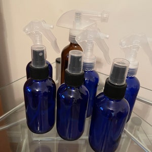 Amber and cobalt blue glass bottles with sprayer or mister tops never used.