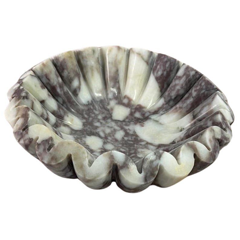 Elegant marble jewelry organizer with natural veining, displayed in bright natural light on a minimalist surface. The smooth polished stone and refined craftsmanship create a luxurious and timeless home decor accent