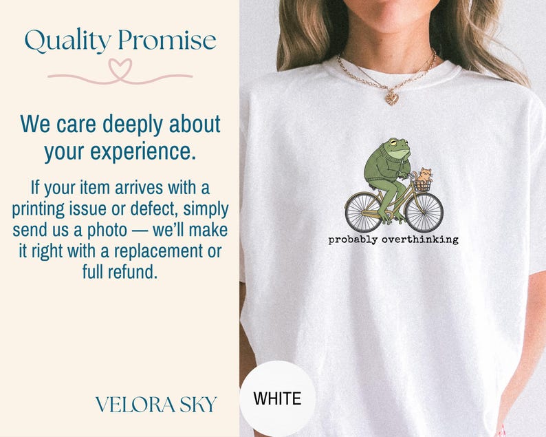 May include: White t-shirt featuring a green frog riding a bicycle with a small cat in the basket. The text "probably overthinking" is printed below the graphic. The shirt also has the text "Quality Promise" and "We care deeply about your experience."