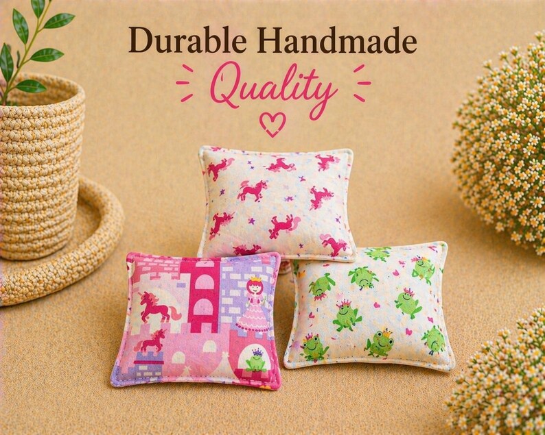 May include: Three small square fabric pillows featuring colorful prints. One pillow has pink unicorns, another displays a pink castle with a princess and frog, and the third features green frogs. Text reads Durable Handmade Quality.