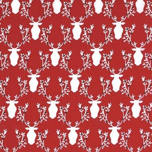May include: Red fabric with a white repeating pattern of stylized reindeer heads with antlers and leaves.
