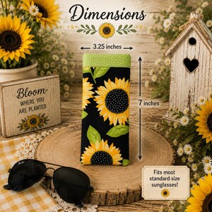 May include: A rectangular fabric glasses case featuring a sunflower pattern on a black background with a green polka dot top border. The case measures 3.25 inches wide by 7 inches tall and is labeled to fit most standard size sunglasses.