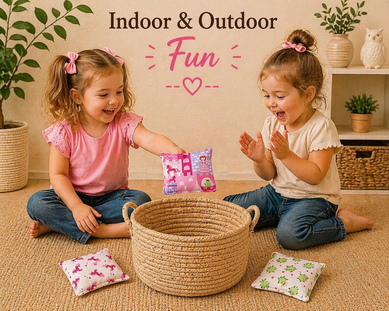 May include: A round woven rope basket with two handles, accompanied by three small square fabric bean bags featuring patterns of unicorns, castles, and green frogs. The text Indoor & Outdoor Fun is displayed above the items.