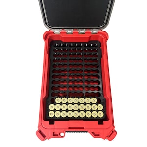 May include: A red, open, rectangular storage case with a black interior. The case contains a black foam insert with multiple circular cutouts, holding several brass-colored cartridges. The case has a black lid.