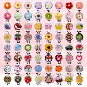 May include: A selection of 64 colourful, handmade crochet appliques featuring diverse designs such as flowers, animals, and food. Each applique is numbered and displayed against a pink backdrop, highlighting the range of available designs.