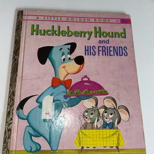 May include: Vintage children's book titled "Huckleberry Hound and His Friends." The cover features a light blue cartoon dog with a red bow tie holding a covered dish, with two gray mice at a table. The book has a pink background.