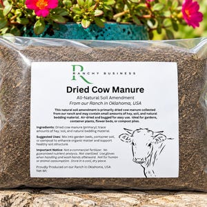 May include: A clear plastic bag filled with brown dried cow manure soil amendment. The white label features the text Ranchy Business, Dried Cow Manure, All-Natural Soil Amendment, From our Ranch in Oklahoma, USA, and a line drawing of a cow.