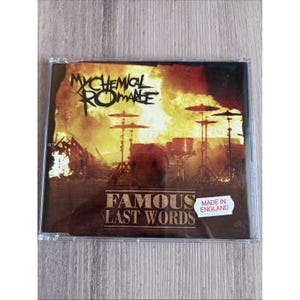 May include: A My Chemical Romance Famous Last Words CD in a clear plastic jewel case. The cover art features a fiery orange and yellow background with a drum kit silhouette and the text My Chemical Romance and Famous Last Words. A white sticker reads Made in England.