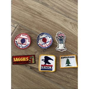 May include: A collection of embroidered patches with various designs and text. Includes patches with the text "Fight Inflation Public Enemy," a U.S. Mail logo, and "An Appeal to Heaven." The patches are in various shapes and colors.
