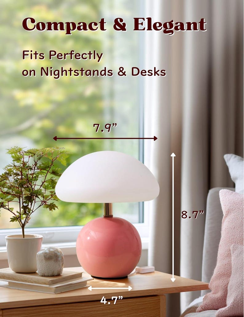 May include: A compact and elegant table lamp with a pink spherical base and a white mushroom-shaped shade. The lamp is 8.7 inches tall, 7.9 inches wide, and 4.7 inches deep. Text on the image reads "Compact & Elegant" and "Fits Perfectly on Nightstands & Desks."