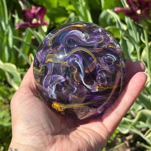 Handblown Glass Paperweight: Purple, Gold, and White Ribbon Orb