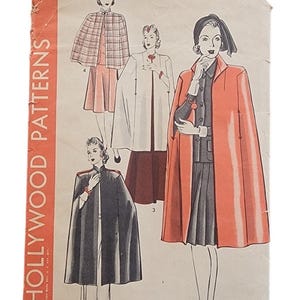 May include: A vintage Hollywood Patterns sewing envelope, number 649, size 14. The paper cover features illustrations of four different cape and coat designs, with text including the brand name, pattern number, and size clearly printed on the front.