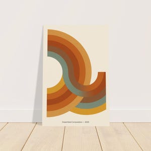 May include: An art print with a retro design, featuring curved, layered shapes in orange, brown, and teal on a cream backdrop. The print includes the text "Dreamfield Composition - 2025". The artwork is displayed against a white wall and wooden floor.