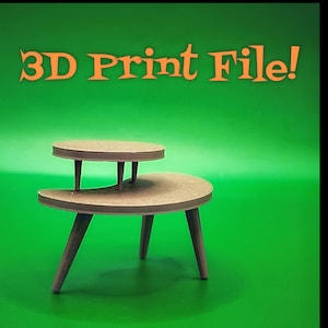 May include: A brown, two-tiered, mid-century modern style table with three legs. The top tier is circular, and the lower tier is a half-moon shape. The text "3D Print File!" is in orange on a green background.