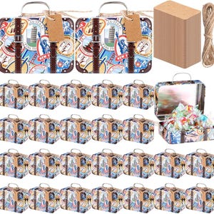 May include: A collection of miniature suitcase-shaped tins with travel-themed designs. The tins feature images of landmarks like the Statue of Liberty and the Leaning Tower of Pisa. Brown tags and twine are included, along with a stack of rectangular cards.