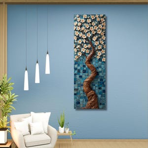 May include: A vertical wall art piece depicting a tree with white flowers and a textured brown trunk against a blue mosaic background. The room features a light blue wall, a beige curtain, and a white armchair with pillows.
