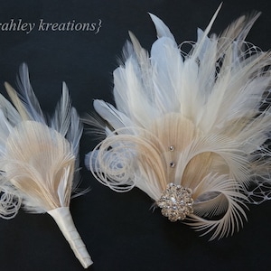 May include: Two feather bouquets in ivory and beige with a rhinestone brooch. The larger bouquet has a netting overlay.
