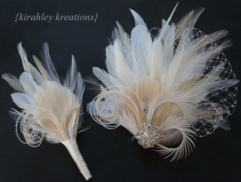 May include: Two feather bouquets in ivory and beige with a rhinestone brooch. The larger bouquet has a netting overlay.