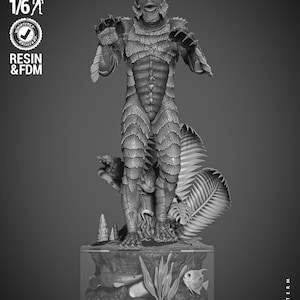 May include: A grayscale resin statue of the Creature from the Black Lagoon, standing on a detailed aquatic base with fish and plants. The figure is highly detailed, with textured scales and fins. The base has the text "CREATURE BLACK LAGOON".