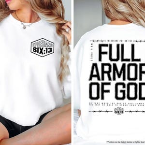 May include: White sweatshirt with the text "EPHESIANS SIX:13" on the front and "FULL ARMOR OF GOD" on the back. The design is in black, with a hexagon shape on the front and a barbed wire design.