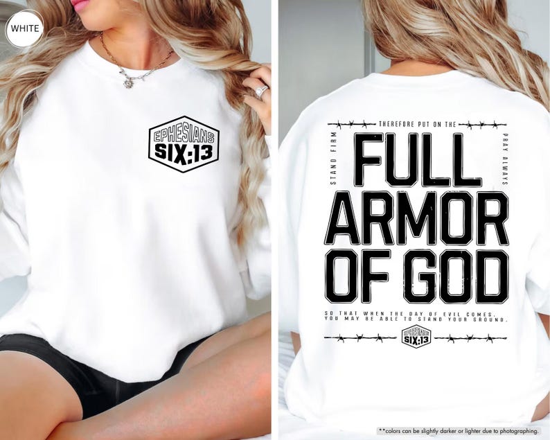 May include: White sweatshirt with the text "EPHESIANS SIX:13" on the front and "FULL ARMOR OF GOD" on the back. The design is in black, with a hexagon shape on the front and a barbed wire design.
