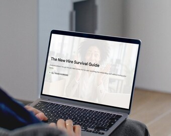 May include: A person using a laptop with the text "The New Hire Survival Guide" on the screen. The laptop is open, displaying the guide's title and some introductory text. The screen shows a surprised woman.