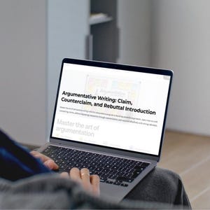 May include: A laptop screen showing the text "Argumentative Writing: Claim, Counterclaim, and Rebuttal Introduction." The screen displays a guide to building arguments. The laptop is open, with the keyboard visible, and is being used by a person.