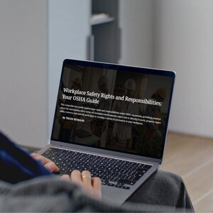 May include: A laptop screen showing the text "Workplace Safety Rights and Responsibilities: Your OSHA Guide". The screen displays images of workers and text about workplace safety. A person is using the laptop, which is on their lap.