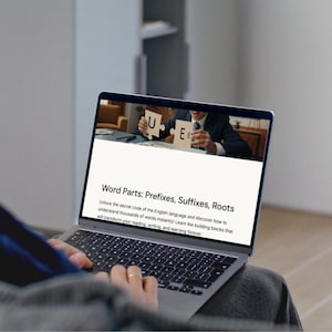May include: A person using a laptop with the text "Word Parts: Prefixes, Suffixes, Roots" on the screen. The screen also shows a person holding puzzle pieces with the letters "U" and "E". The laptop is on a person's lap.