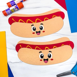 Op de afbeelding: Twee papieren hotdog-uitsparingen met een beige broodje, een rode worst en gele mosterd. Elke uitsparing heeft een cartoongezicht met grote zwarte ogen, een lachende mond en roze wangen. Twee oranje lijmstiften en een blauwe schaar zijn ook zichtbaar.