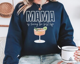 May include: A navy blue sweatshirt with the text "MAMA is living the best life" and a watercolor illustration of a margarita.