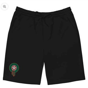 Peut inclure: Short noir avec une taille élastique à cordon et des poches. Un emblème circulaire avec une couronne et des accents rouges et verts est sur la jambe gauche. Le short est en matière souple.