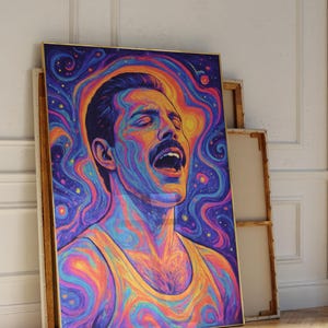 May include: A vibrant portrait of a man with a mustache, rendered in psychedelic colors. The artwork features a swirling, cosmic background and the subject is wearing a yellow tank top. The image is framed and leans against a wall.