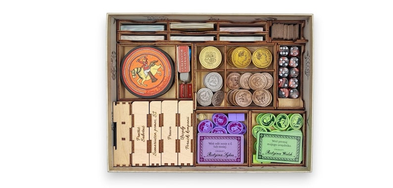 May include: Wooden board game organizer with compartments for cards, dice, tokens, and coins. Includes a circular game piece with a knight on horseback and various game components in a wooden box.