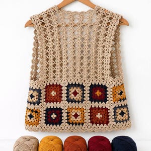 May include: A sleeveless crochet vest featuring a beige openwork upper section and a lower section composed of multicoloured granny squares in shades of navy blue, mustard yellow, and deep red, displayed with five matching yarn balls and a crochet hook.