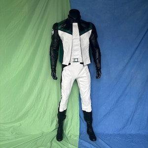 May include: A full-body costume featuring a white jacket with a green and black design, black sleeves, and matching white pants with black accents. The costume includes black gloves and boots, and a belt buckle with a circular emblem. The outfit is displayed on a mannequin.