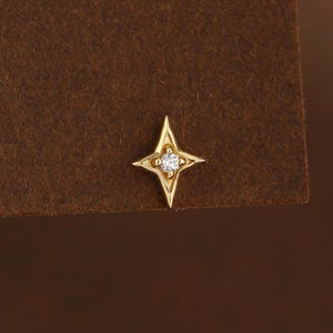 Pendiente de oro macizo de 14 quilates con circonita cúbica transparente en forma de estrella, de base plana, para cartílago o para piercing de hélice, concha o tragus.