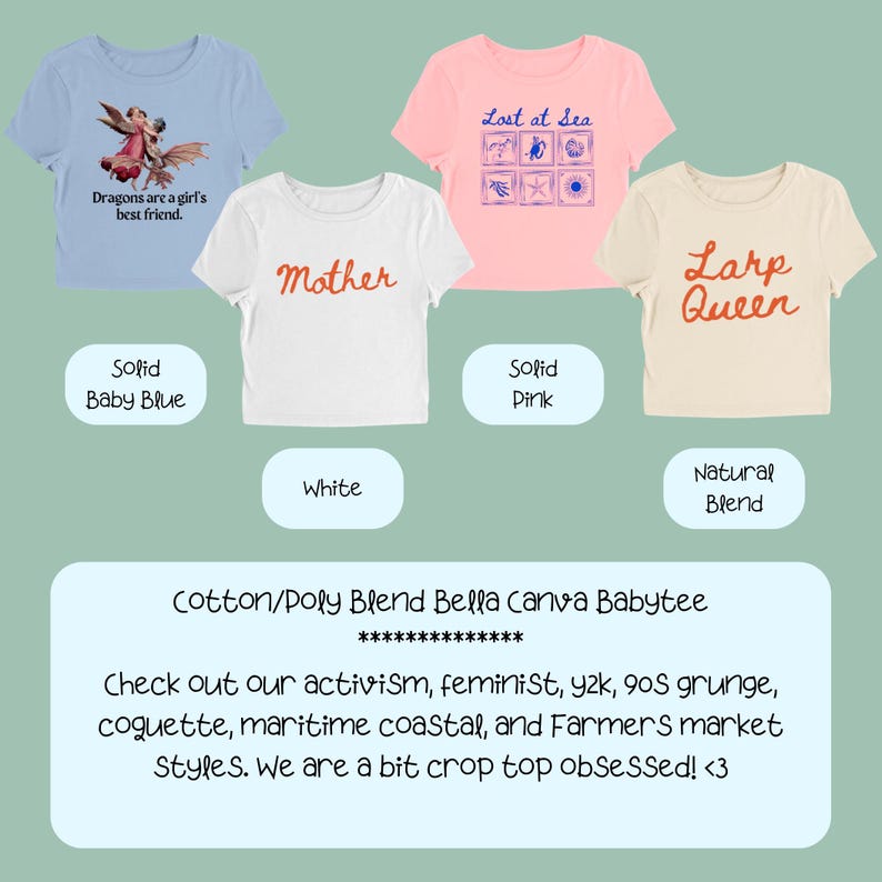 May include: Four short-sleeve crop tops in baby blue, white, pink, and natural blend. The baby blue top features a dragon graphic with the text 'Dragons are a girl's best friend.' The white top says 'Mother,' the pink says 'Lost at Sea,' and the natural says 'Larp Queen.'