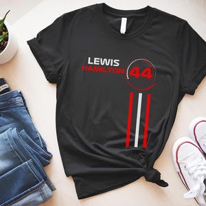 May include: Black t-shirt with white and red text that says "Lewis Hamilton 44".