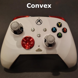 May include: White Xbox controller with red and gray custom buttons. The buttons are labeled "X", "Y", "A", and "B".
