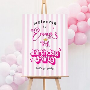May include: Pink and white striped welcome sign with the text "Welcome to Emma's 12th Birthday Party Let's go party!" in pink and black lettering. A gold crown is above the name Emma.