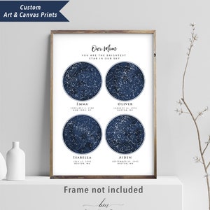 May include: A navy blue and white star map print with four constellations representing the birth dates of four children. The print reads "Our Mom You Are The Brightest Star In Our Sky" and includes the names Emma, Oliver, Isabella, and Aiden with their birth dates and locations. The print is framed and has the text "Frame not included" and "Blissful Melody Design" at the bottom.