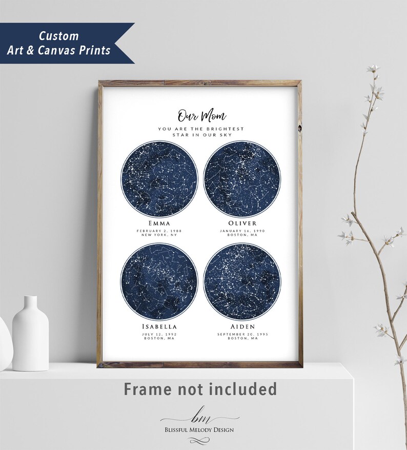 May include: A navy blue and white star map print with four constellations representing the birth dates of four children. The print reads "Our Mom You Are The Brightest Star In Our Sky" and includes the names Emma, Oliver, Isabella, and Aiden with their birth dates and locations. The print is framed and has the text "Frame not included" and "Blissful Melody Design" at the bottom.
