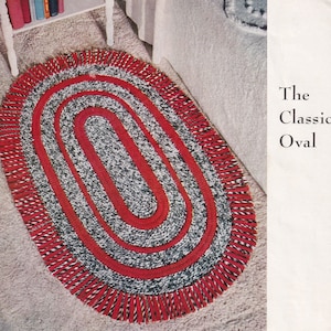 May include: A red and white oval rug with a fringe border. The rug is made of braided yarn and has a classic design. The text "The Classic Oval" is printed on the right side of the image.