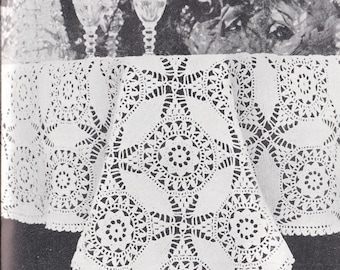 May include: A white crocheted tablecloth with a delicate floral pattern. The tablecloth is laid out on a table with two crystal glasses and a pitcher.